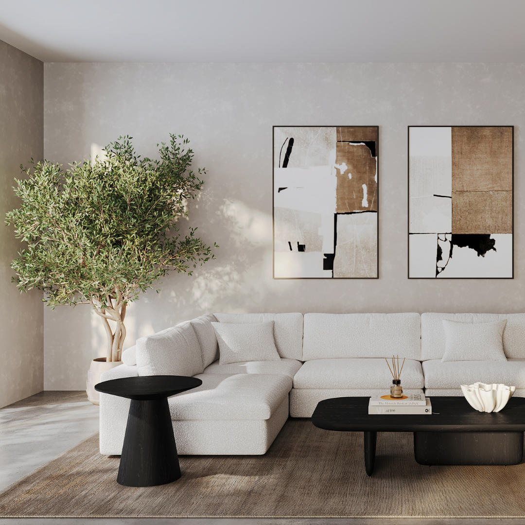 Scandinavian living room with white sectional sofa, black coffee table, minimalist wall art, and indoor tree for a calm and airy aesthetic