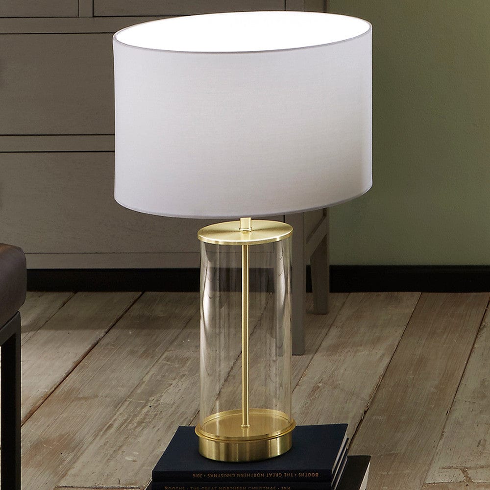 Westwood Clear Glass and Champagne Metal Table Lamp with Harry 35cm Ivory Poly Cotton Cylinder Drum Shade.