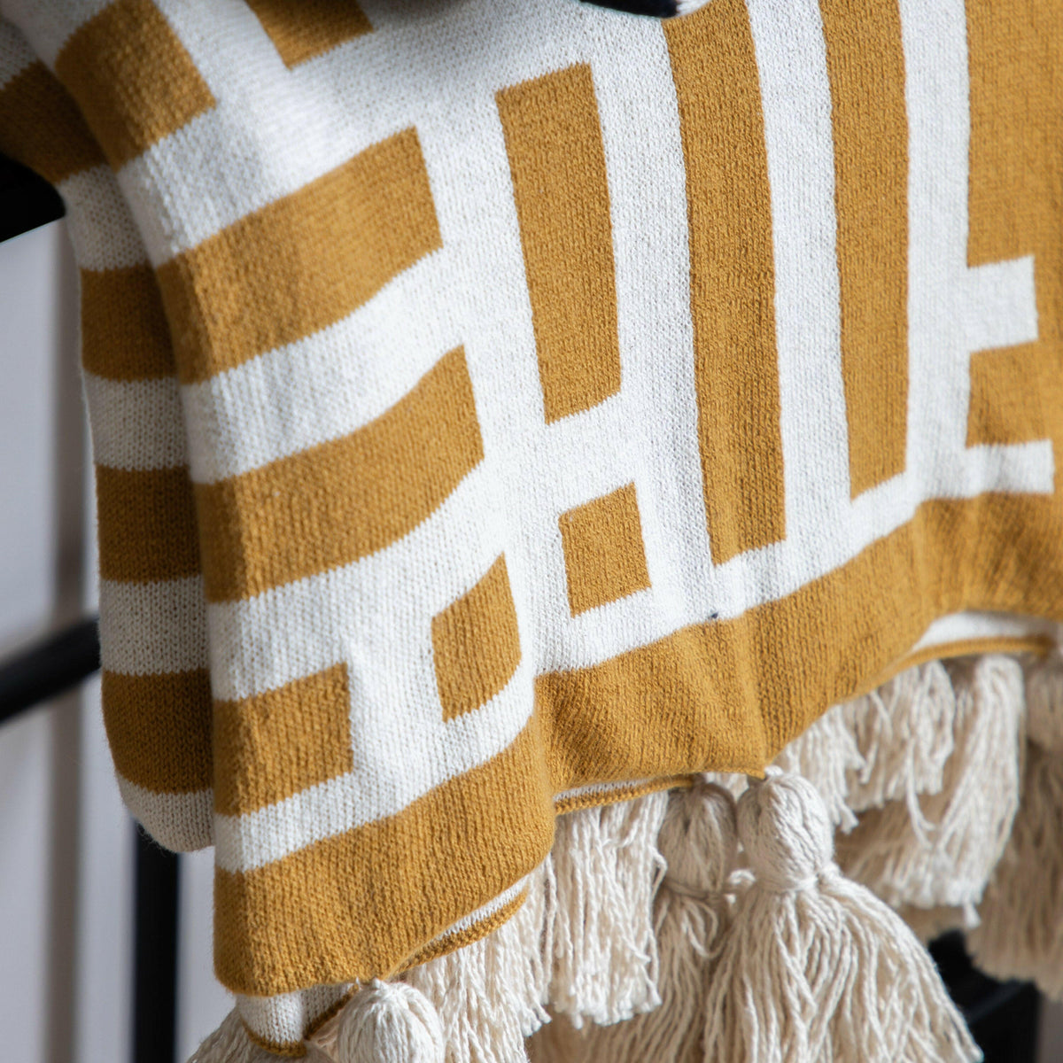 Devoran Knitted Tassel Throw Ochre.