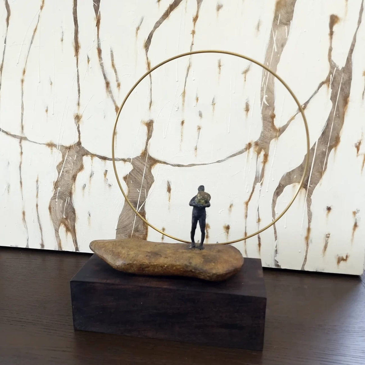 Bronze Figure On Rock With Ring.